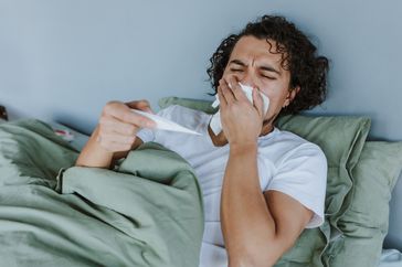 Sick man lying in bed