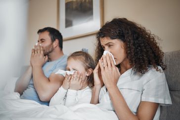 Family sneezing outdoors in springtime