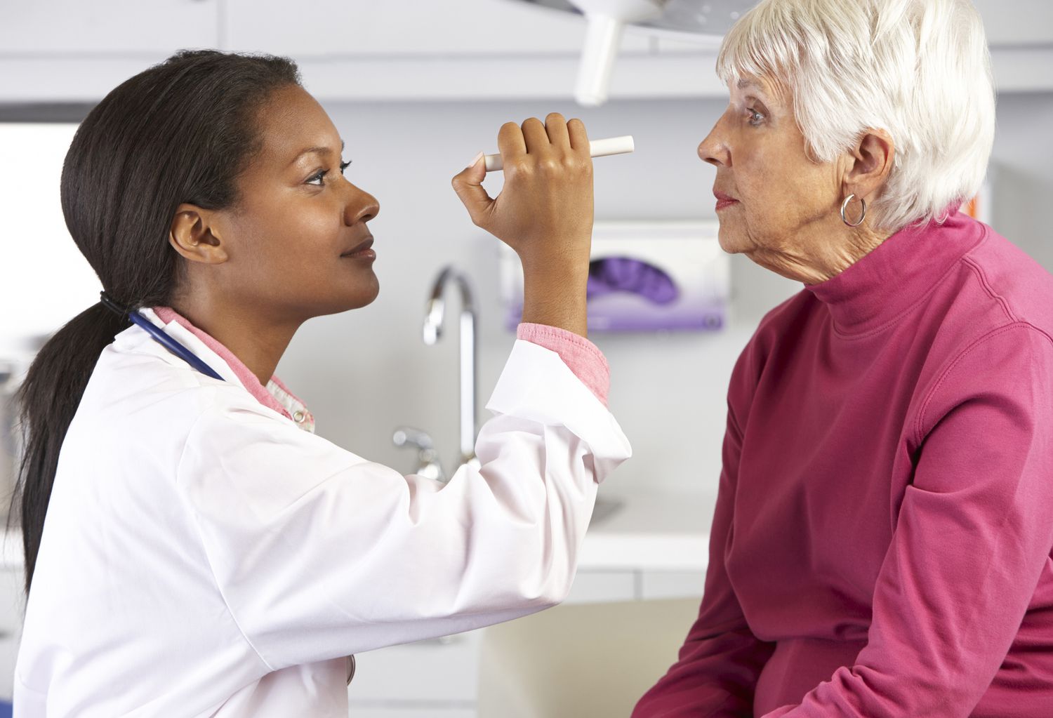 Doctor examines patient with stethoscope