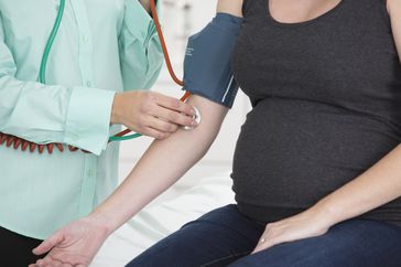 Doctor checking patient's blood pressure