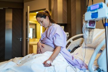 Pregnant woman resting in hospital bed